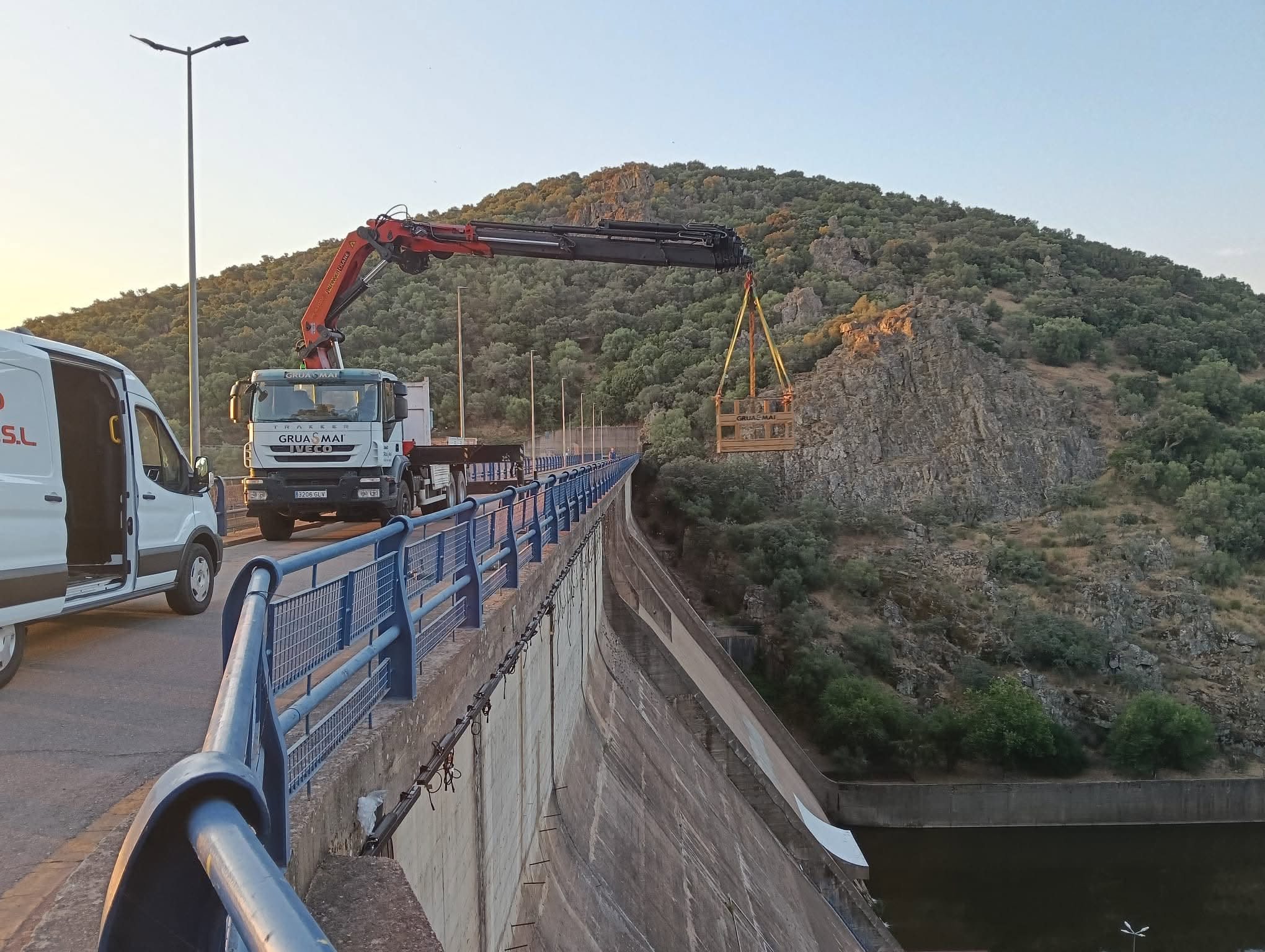 Camión pluma de Grúas MAI con cesta colgante trabajando en altura sobre la presa de Villar del Rey, Badajoz