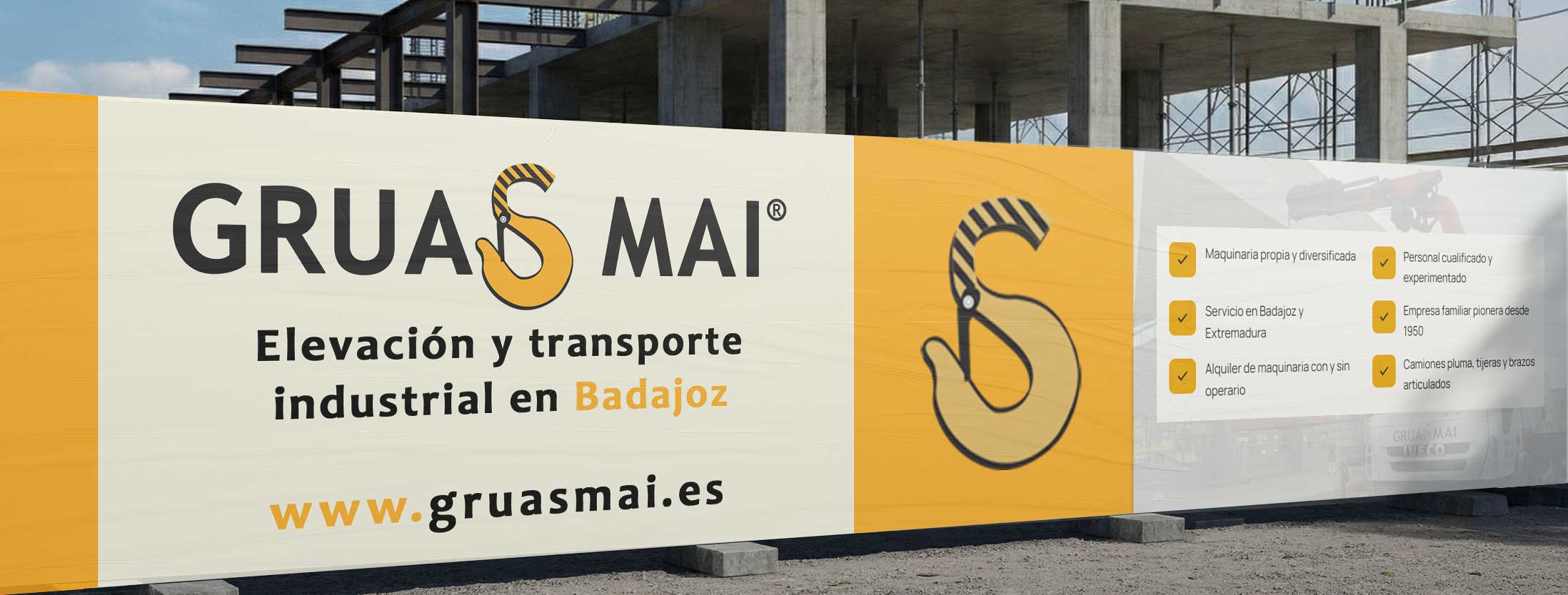 Valla publicitaria de Grúas MAI en una obra de construcción en Badajoz — Elevación y transporte industrial en Badajoz desde 1950